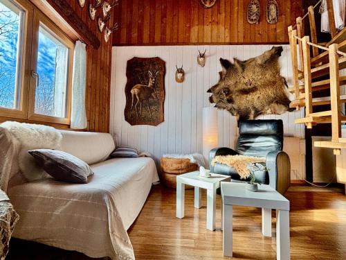 a living room with a couch and two tables at Le Refuge du Trappeur in Crémines