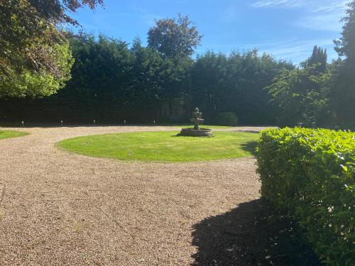 a park with a statue in the middle of the grass at Barncroft Luxury Bed & Breakfast in Solihull