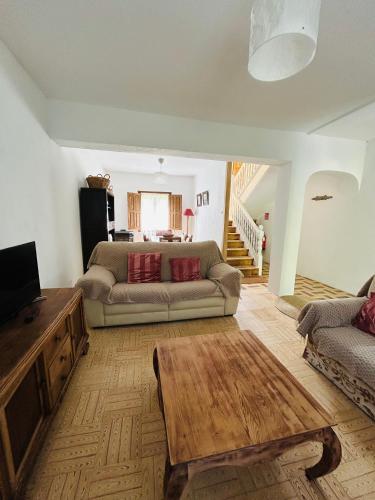 a living room with a couch and a coffee table at Casa de los Valles en RioNansa in Puentenansa