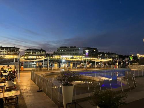 a rooftop patio with a swimming pool at night at Estadía de Lujo con vista soñada a la Bahía grande de Nordelta in Benavídez