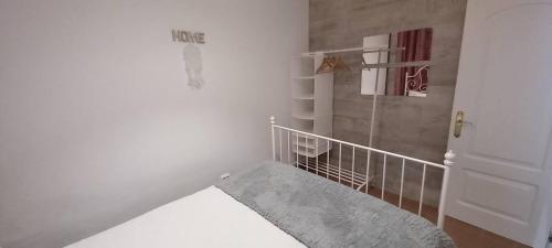 a white room with a staircase and a door at Alojamento cosy in Fuzeta