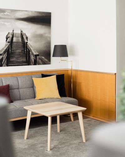 a living room with a couch and a coffee table at Hotel Waltikka in Valkeakoski