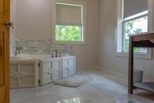 a white bathroom with a sink and a mirror at Springs Wish in Eureka Springs