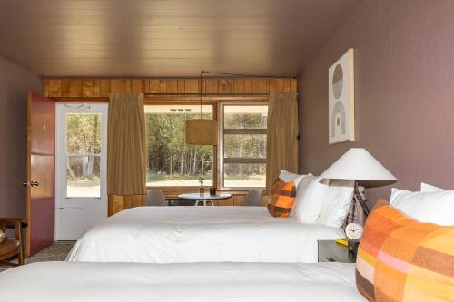 a bedroom with two beds and a window at The Ellison Inn & Lounge in Ellison Bay
