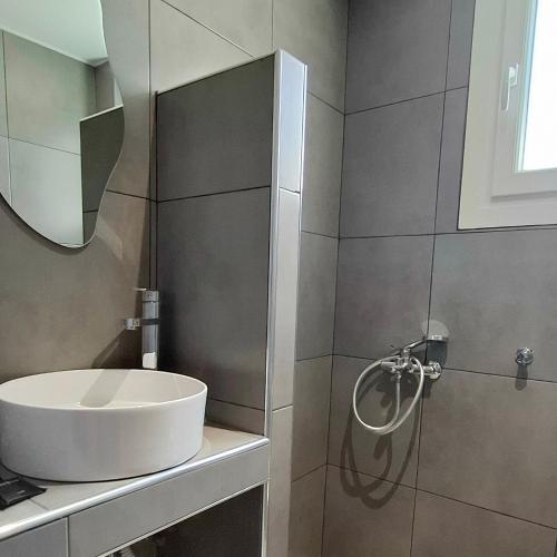 a bathroom with a sink and a mirror at Georgia apartments in Stafylos