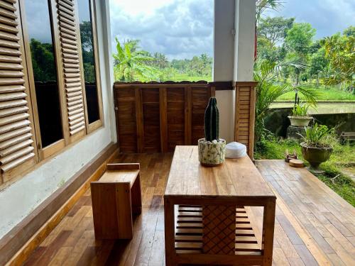 a porch with a table and a cactus on it at Pesona 361 Alam Bungalows in Rarang