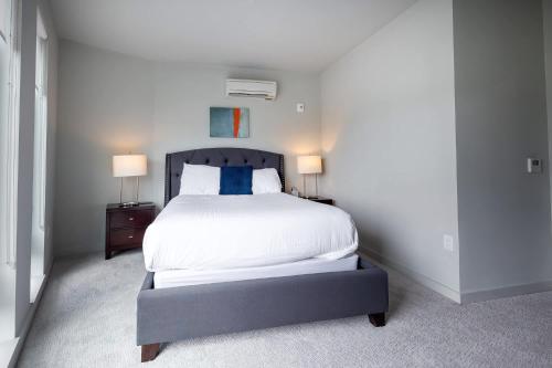 a bedroom with a large bed with two lamps at Luxury Private Apt with Pool in White Plains