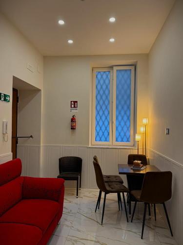 a living room with a red couch and a table at AuRoom in Naples