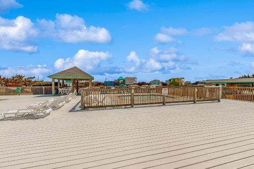 a deck with chairs and a gazebo on a beach at Prickly Pear 723 in Avon