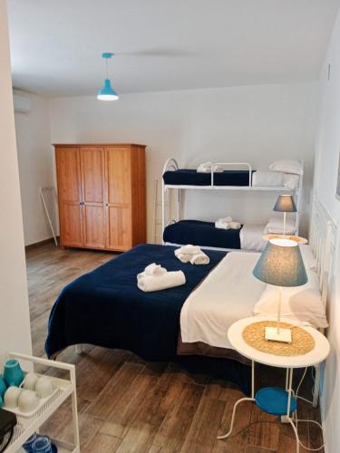 a bedroom with a bed and two bunk beds at Brezza Marina Studios in Montesilvano
