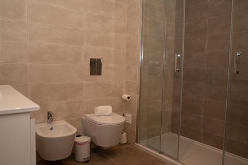 a bathroom with a shower and a toilet and a sink at Sunset Horizon - BY SCH in Pederneira