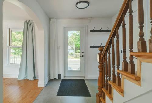 a hallway with a staircase and a glass door at 891 shefford 4-bedroom house in Bromont