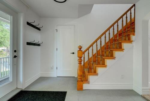a hallway with a wooden staircase in a home at 891 shefford 4-bedroom house in Bromont