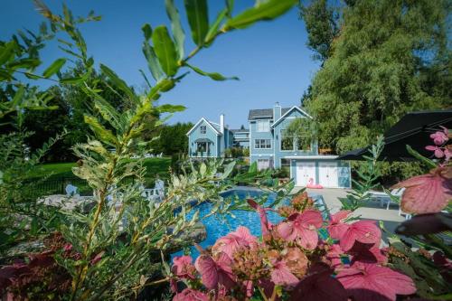 a view of a house from a garden with flowers at 891 shefford 4-bedroom house in Bromont