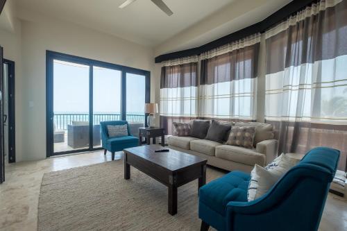 a living room with a couch and a table at Diamante Beachfront Suites in San Pedro