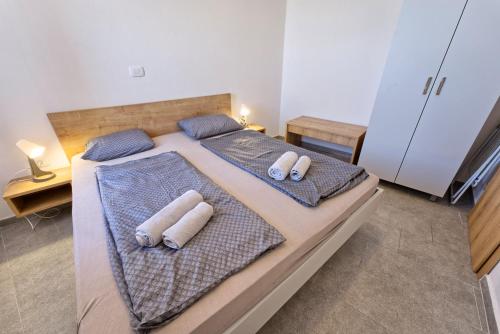 a bedroom with a bed with towels on it at Apartments Punta Piran in Piran