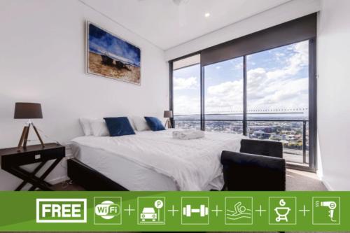 a bedroom with a bed and a large window at Spacious 2Bed Apartment plus Nook with River View in Brisbane