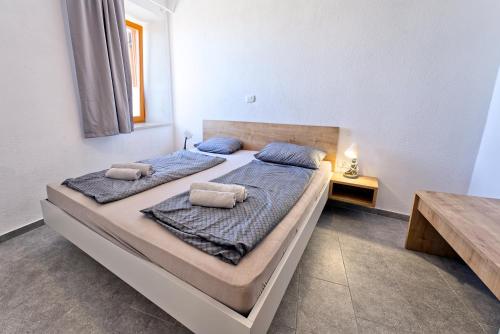 a bedroom with two beds and a table at Apartments Punta Piran in Piran