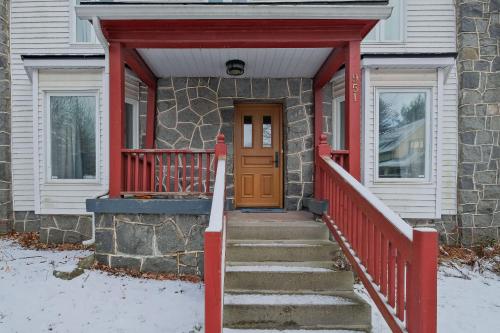 a house with a red front door and stairs at 951 Shefford 4 bedrooms house in Bromont