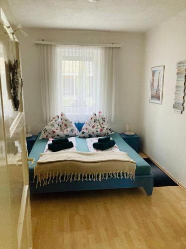 a bedroom with a large bed with a window at Das Ferienhaus-zurück zum Ursprung in Güssing