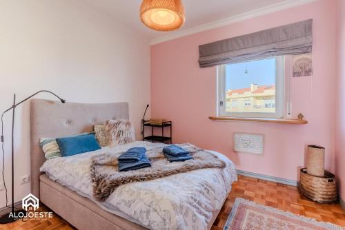 a bedroom with a bed with blue pillows on it at Nomad's Surf and Sunset Haven - Ocean View in Santa Cruz in Santa Cruz
