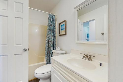 a white bathroom with a sink and a toilet at Moon Palace 687 in Salvo