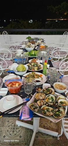 a long table with plates of food on it at Vung Tau Villa mini sát biển - Gitico Homestay in Vung Tau