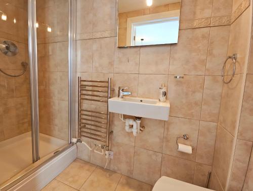 a bathroom with a sink and a shower at Relaxing coastal getaway in Mortehoe, Woolacombe in Mortehoe
