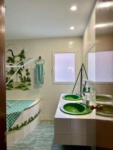 a bathroom with two green sinks and a window at Cozy Flat with City & Beach in Puerto de Sagunto