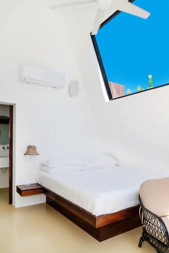 a bedroom with a bed and a mirror at Sand and Sky Resort Adults Only in Basil Jones
