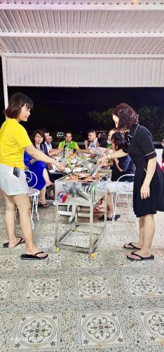 a group of people standing around a table at Vung Tau Villa mini sát biển - Gitico Homestay in Vung Tau