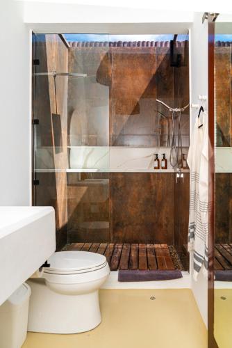 a bathroom with a toilet and a shower at Sand and Sky Resort Adults Only in Basil Jones