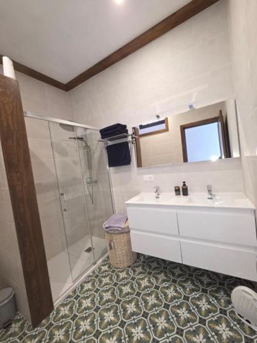 a bathroom with a sink and a shower at La Casa de Iya in Las Indias