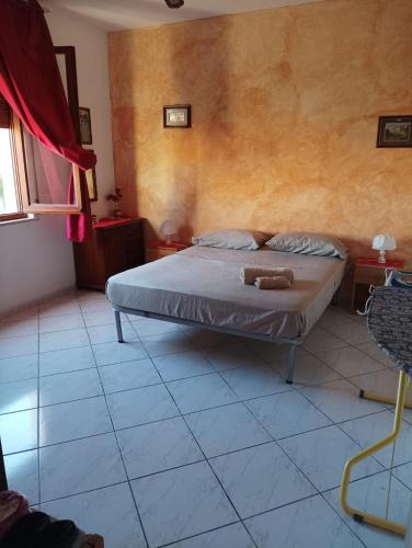 a bedroom with a bed with two teddy bears on it at Le Fontanelle Apartment in Siniscola