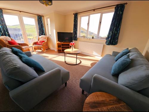 a living room with two couches and a tv at Relaxing coastal getaway in Mortehoe, Woolacombe in Mortehoe