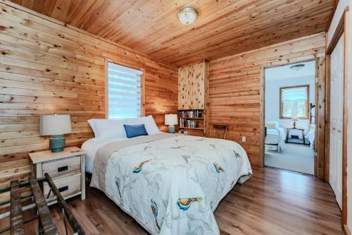 a bedroom with a bed and a wooden wall at Lakeview Loft A-frame Escape Tobermory in Tobermory