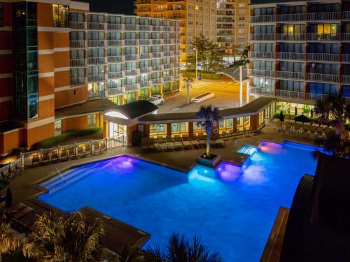 an overhead view of a large swimming pool at night at Holiday Inn & Suites Virginia Beach - North Beach by IHG in Virginia Beach