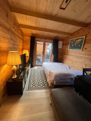 a bedroom with a bed in a log cabin at The Greenbanks Escape in Killarney