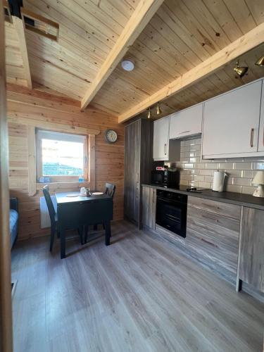 a kitchen with a table and chairs in a room at The Greenbanks Escape in Killarney