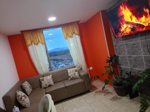 a living room with a couch and a fireplace at Ipiales puerta de oro in Ipiales