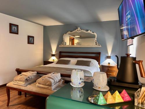 a bedroom with a bed with a table and a mirror at Relais Villa Alma in Castion Veronese