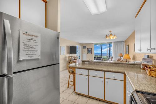 a kitchen with a stainless steel refrigerator in a room at Kauhale Makai 335 in Kihei