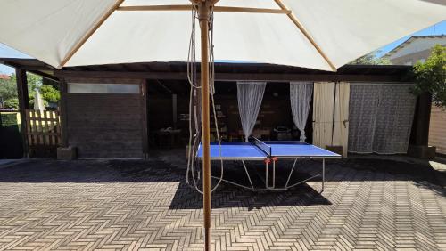 an umbrella on a table in a patio at Itaca in Lido di Fermo