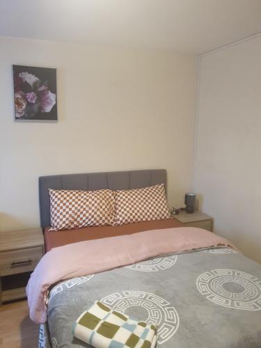 a bedroom with a large bed with at Four Large Double With Ensuites in Abbey Wood