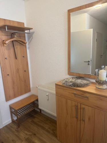 a bathroom with a mirror and a wooden dresser at Ferienwohnung Valentina in Bad Neuenahr-Ahrweiler