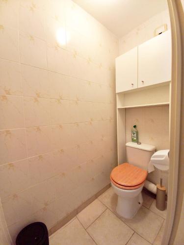 une salle de bain avec toilettes avec un siège de toilette en bois dans l'établissement Studio Cosy Fréjus Plage - Clim, WIFI & Parking, à Fréjus