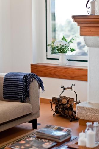 a living room with a couch and a window at Herdade do Gamito in Crato