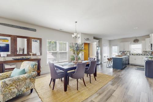 a kitchen and dining room with a table and chairs at The Salty Pecan in Morehead City