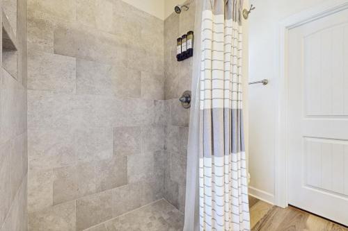 a bathroom with a shower with a shower curtain at The Salty Pecan in Morehead City