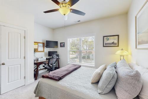 a bedroom with a bed with a ceiling fan at The Salty Pecan in Morehead City